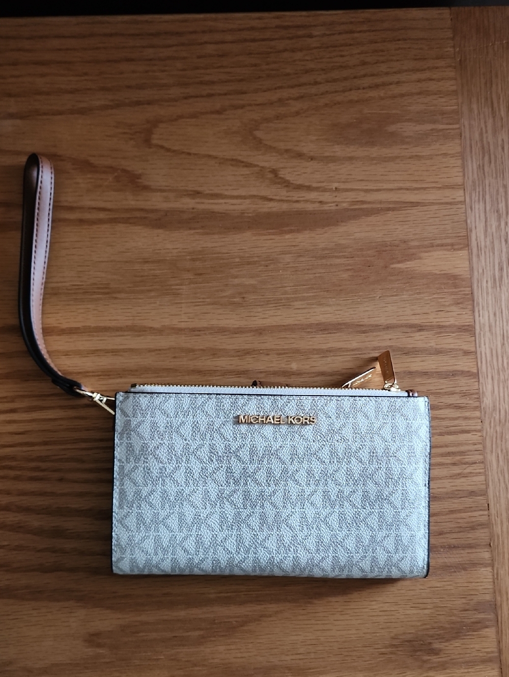 NWOT - Michael Kors Silver Logo Wristlet with Gold-Tone Accents. Offers Welcome
